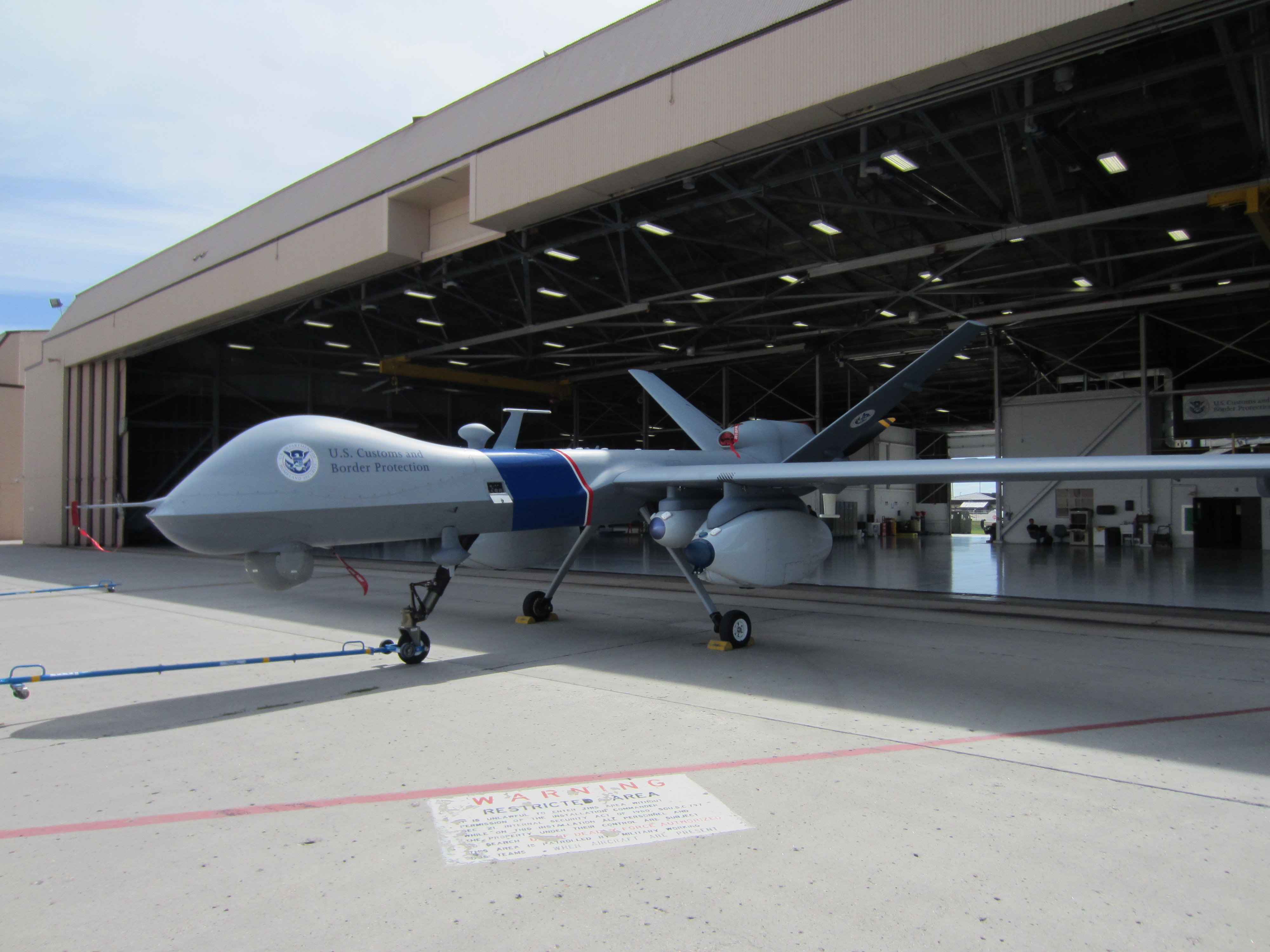 A large drone emerging from a a hangar