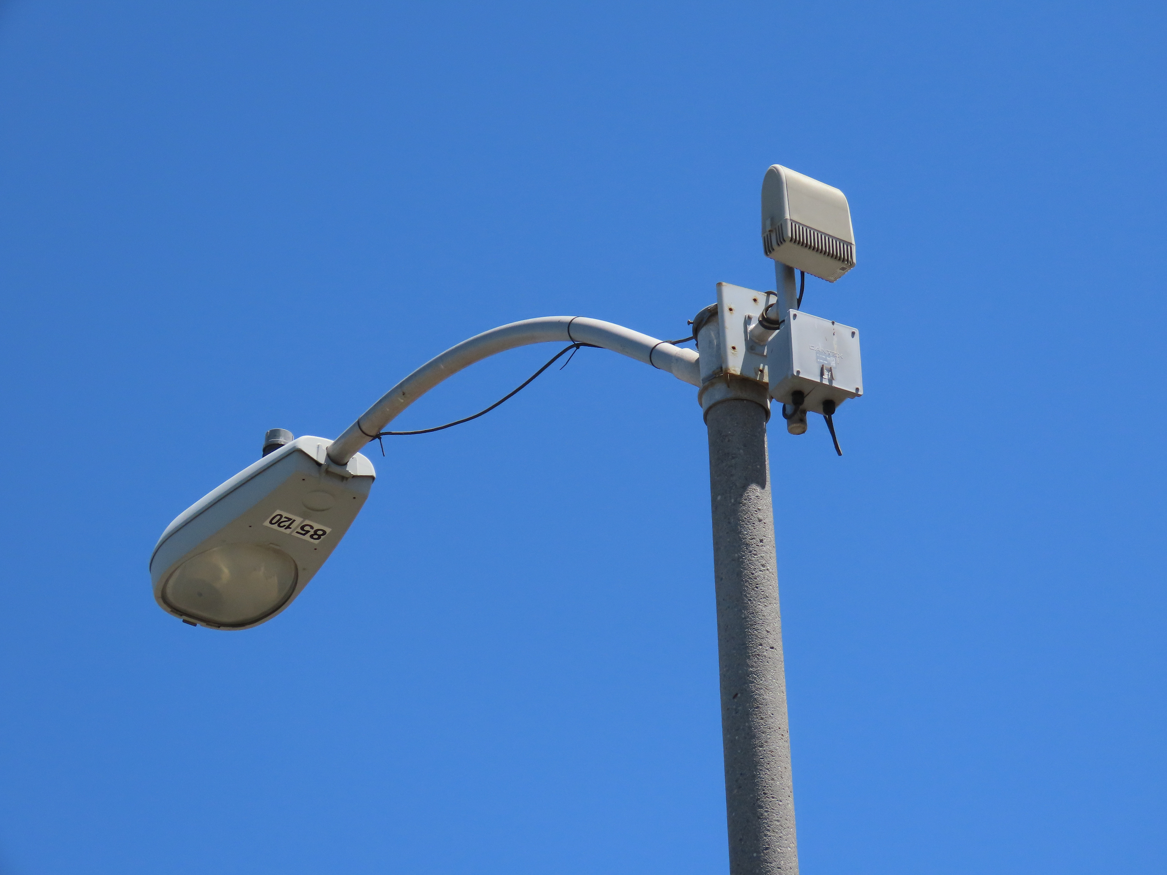 A Shotspotter sensor attached to a streetlight